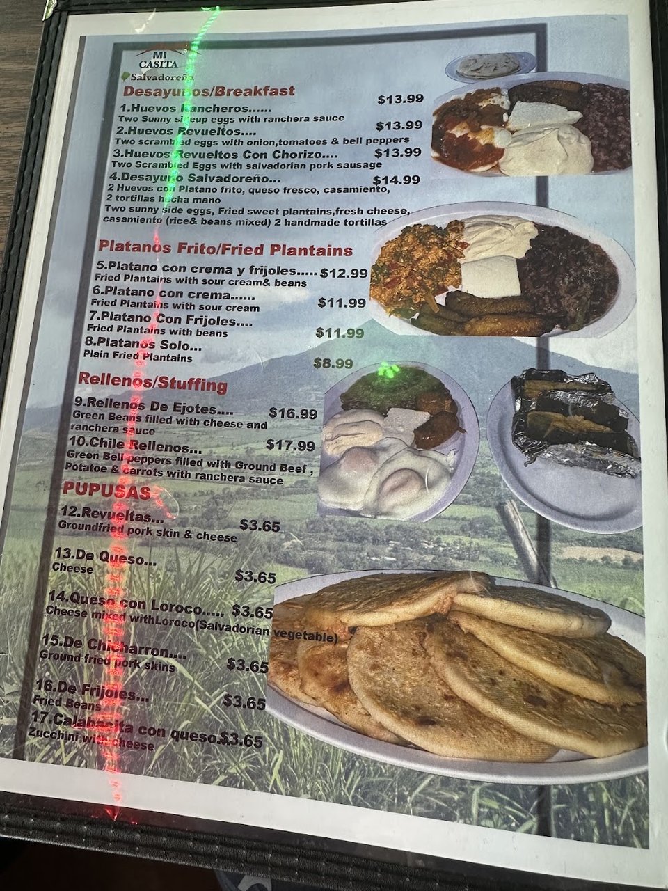 Printed menu showing pupusas and grilled shrimp.